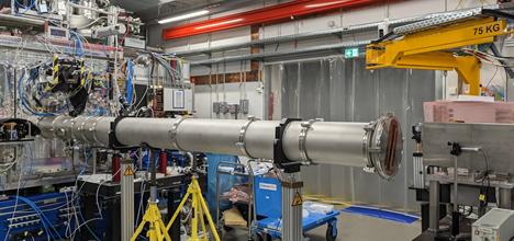 Experimental hall showing the target interaction chamber (left), the collection vacuum tube and the detector (right)