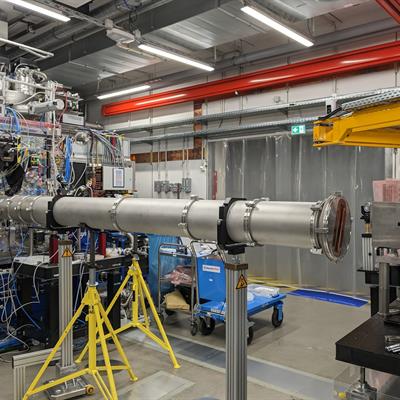 Experimental hall showing the target interaction chamber (left), the collection vacuum tube and the detector (right)