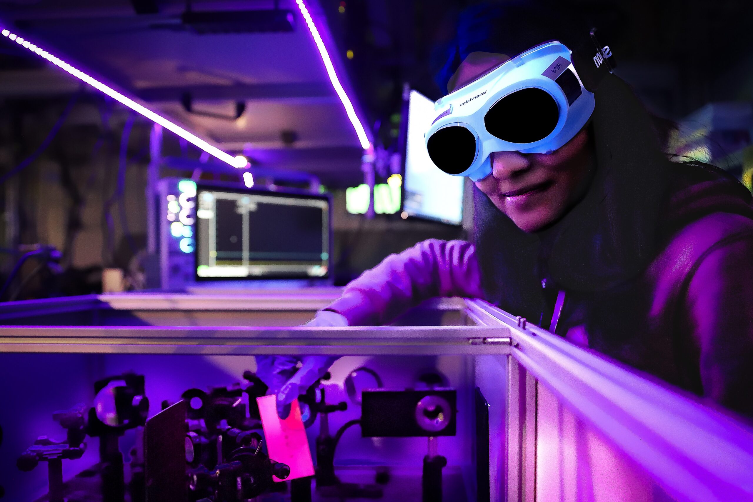 Researcher operating laser technology at the Central Laser Facility